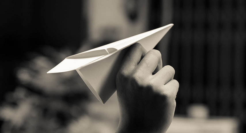  hand holding paper plane  